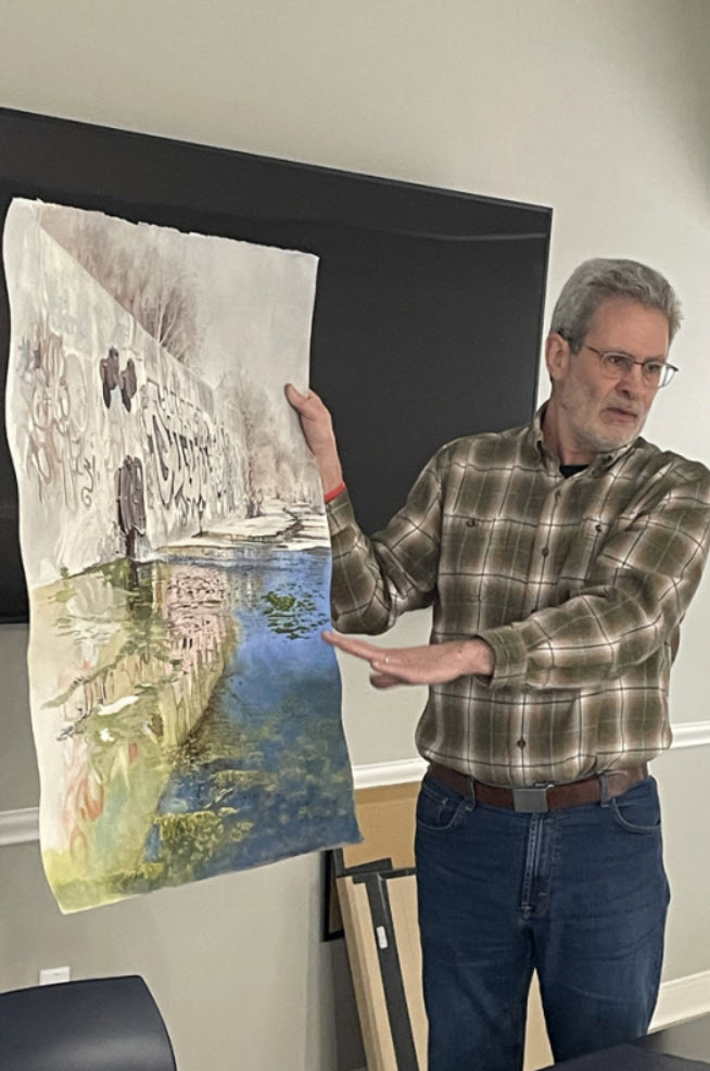 Tom Schroeder discussing his painting